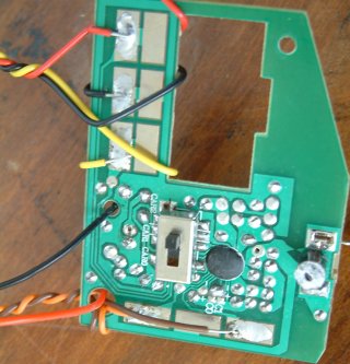 The remote with wires soldered on.